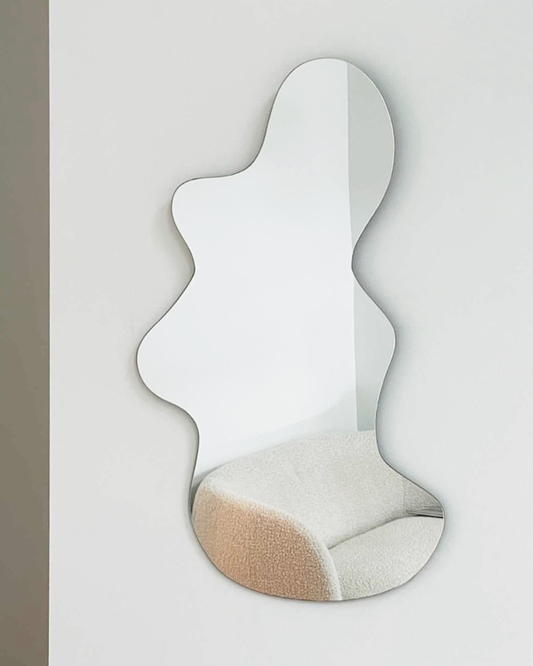 Asymmetrical and irregular curvy wall mirror in apartment living room  